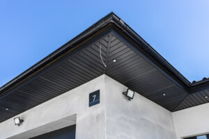 A modern graphite herringbone roof lining is attached to the trusses, visible turned on LED lights.